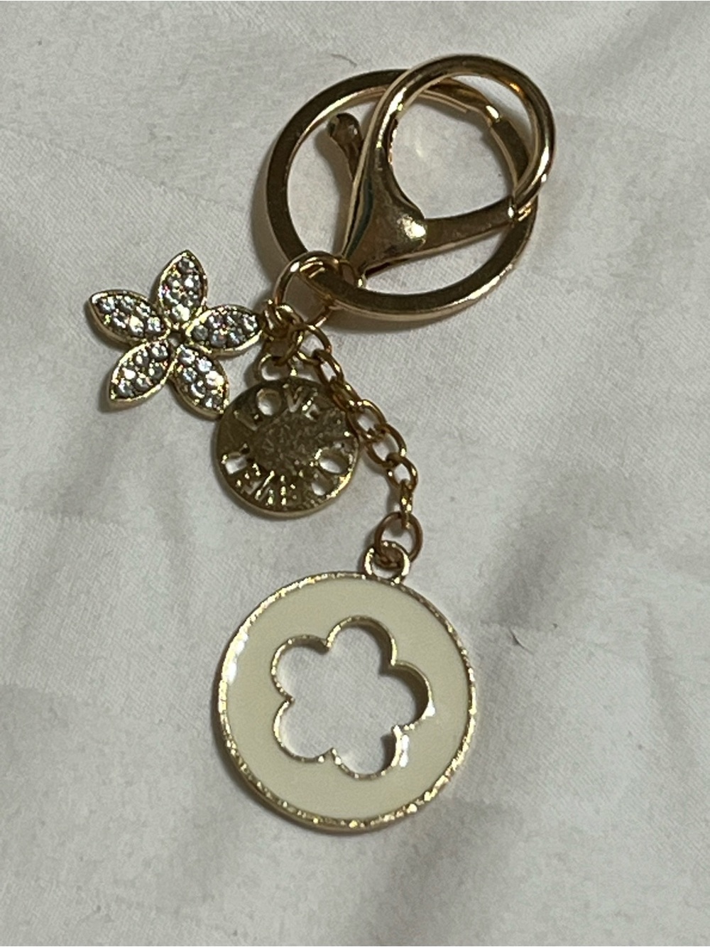 Gold-Tone Keychain with White Enamel Flower Accent